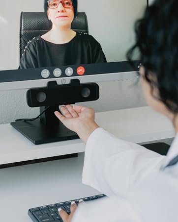 A doctor adjusts the volume on a speaker bar